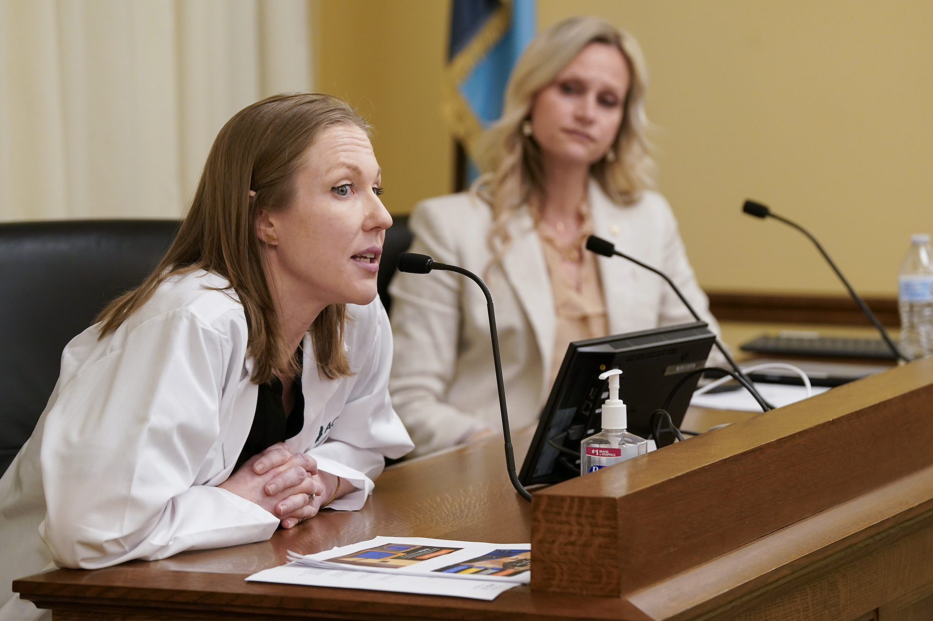 Dr. Erin Stevens, chair of the Minnesota Chapter of the American College of Obstetricians and Gynecologists, testifies before the House Health Finance and Policy Committee Feb. 12 against HF24, sponsored by Rep. Krista Knudsen, right. (Photo by Michele Jokinen)